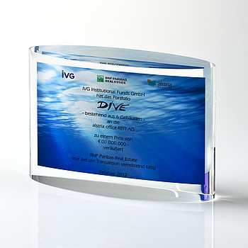 Financial tombstone made of clear acrylic glass curved on both sides.